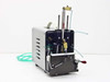 Ultramation OA-4 Pneumatic Linear Thruster Custom Pump – right-side angle view showing Bimba stainless cylinder rods, brass fittings, green pneumatic tubing, and metal enclosure with ventilation slots