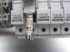 Close-up of Ferraz Shawmut ULTRASAFE fuse holders on DIN rail — open fuse holder displaying Littelfuse KLKD 2 fast-acting 2A fuse, fuse holder labels showing 800V/30A UL and 690V/32A IEC ratings