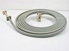 Micro-Coax 1010 WR-62 Ku-Band flexible waveguide delay line coiled overhead view showing full 20-ft length with both flanged ends visible