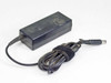 HP 463552-004 AC adapter — angled view showing dust and surface scuffing on top of the black plastic housing