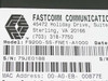 Fastcomm F9200-SS-FNE1-A1000 label showing model number, serial number S/N 79JE0188, MAC address 00-A0-EB-00877E, and Fastcomm Communications address