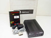 Fastcomm F9200-SS-FNE1-A1000 EtherFRAD open-box contents — unit, manual, power adapter, cable, and adapters with original Fastcomm box