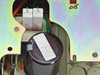 Close-up of main filter capacitor inside Radius 915-0159R power supply with label visible on capacitor body