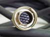 Single JAE circular connector face close-up showing 14-position socket pin arrangement
