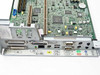 Compaq 296669-001 motherboard in tray — angled view showing rear I/O panel with full port complement and board layout