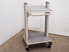 Unbranded white rolling cart with carpeted shelves — front-right three-quarter view showing adjustable top shelf bracket and handle