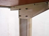 Second close-up of top shelf bracket and column hardware showing bolt pattern on metal corner bracket