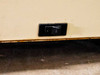 Close-up of rocker power switch on bottom table section — rust and corrosion visible along bottom edge of housing