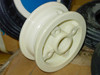 Close-up front view of white plastic two-piece hub showing center axle opening and mounting holes