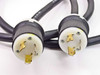 Close-up of both Hubbell twist-lock plugs on the Liebert MP130E input and output power cables