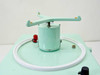 Mattson-Garvin Model 220 rotating slit sampler arm assembly — mint green synchronous motor drum with cross-arm and white circular gasket ring on top of instrument housing