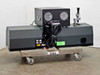 Beckman Coulter Delsa 440SX rear view showing bundled cables, power supply on top, and optical assembly at right on wheeled dolly