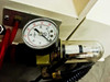 Vacuum/pneumatic panel — Norgren filter-regulator with polycarbonate bowl, pressure gauge, and red vacuum tubing