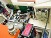 Interior detail — multiple green PCBs with ICs and ribbon cables; secondary circuit board panel with edge connectors; red high-voltage caution label visible