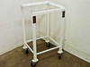 White metal rolling cart 22x20x39 with four swivel castors — front-left three-quarter view showing open frame and rust-spotted corner mounting plates