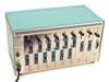 TCL 2110 Multiport Transceiver teal-green variant front-left angled view showing fully populated card slots and POWER switch