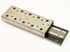 Unbranded linear slide micropositioner stage from front-right angle showing top table surface with multiple tapped mounting holes