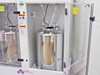 Interior view of FSI ChemFill cabinet with Canister B door open showing stainless steel tank, tubing manifold overhead, pressure gauge, and safety warning labels