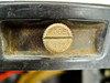 Close-up of Wheelco Model 402 model identification disc showing stamped brass medallion reading MODEL 402