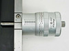 Mitutoyo 197-201 micrometer head mounted on stage rail — shows '0–2in' range and '.0002in' resolution markings with linear scale on rail