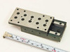 Schneeberger NK 2-80 linear positioning slide top view with ruler — carriage in extended position, multiple tapped holes on carriage surface visible