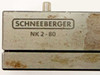 Schneeberger NK 2-80 label close-up — "SCHNEEBERGER NK 2-80" engraved on carriage top, surface wear and light rust visible
