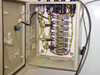 Interior of Systems Chemistry relay control panel showing relay bank, terminal strips, multi-color wiring, and power components