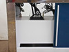 Left side cabinet door open showing internal cable routing and plumbing entering the lower cabinet section