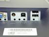 Dell 2001FP rear I/O panel close-up — DC power jack, USB-B upstream port, and two USB-A downstream ports; barcode label CN-0C0646-46633-599-3TWL