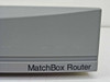 MatchBox Router nameplate close-up on front lower bezel showing light surface scuffing