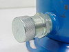 CTI Cryogenics compressor adsorber – close-up of large knurled aluminum threaded cap on helium port fitting