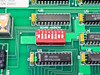 Close-up of board address DIP switch and DM74ALS520N IC with REV 9014 and S/N 250022 label visible