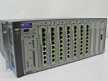 HP J4121A ProCurve Switch 4000M chassis front view showing 7x J4111A 10/100 modules and J4113A Gigabit-SX module installed with green port LEDs illuminated