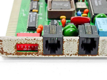 ZX1896A ISA modem card — close-up of bracket showing dual RJ-11 ports and 6-position DP-06 DIP switch with surface rust on bracket