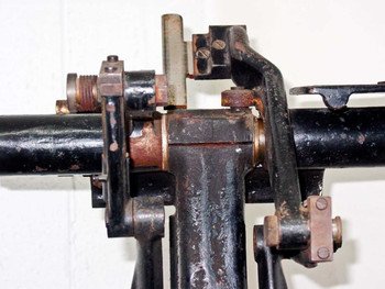 Close-up of F&B/CECO film splicer upper splicing head mechanism showing brass and iron components with surface rust and patina