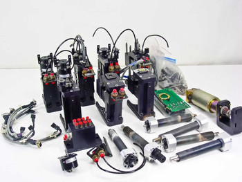 Second overview angle of complete SMC pneumatic parts lot showing actuator assemblies, linear guide cylinders, Pittman motor and loose components