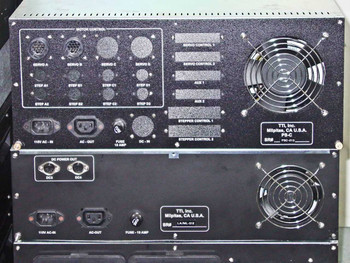 TTI rackmount chassis rear panels — upper unit showing Motor Control section with Servo A/B/C/D and Step connectors, 115V AC-IN, AC-OUT, DC-IN, and Fuse 15A; TTI Inc Milpitas CA label visible; lower unit showing DC Power Out (DC3/DC4), 115V AC-IN, AC-OUT, and Fuse 15A