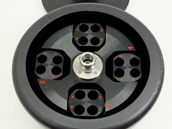 Tomy TMS-4 centrifuge rotor interior showing 4 swing buckets each with 4 tube positions numbered in red, stainless hub