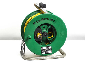 In-Situ PXD-260 pressure transducer with 150ft poly cable on green reel and metal stand – front-right view showing In-Situ Inc. logo and calibration label