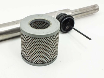 Mann C1337 filter components laid out — cylindrical perforated mesh filter element, black rubber end cap, and stainless steel pole