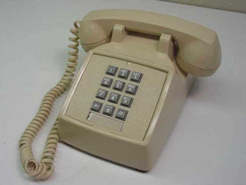 ITT Cortelco 250044-MBA-20M beige touchtone desk telephone – front three-quarter view showing handset and keypad