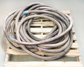 Thermoid Cobra 1.25-inch fuel oil delivery hose coiled on wooden pallet, full length view
