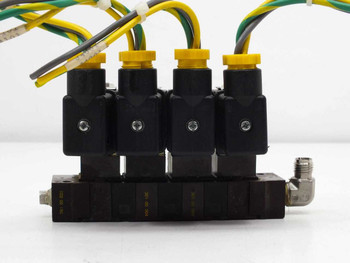 ASCO 10900001 solenoid valve manifold front view showing four yellow-capped coil bodies mounted on manifold block