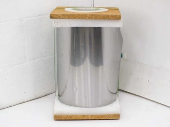Hamilton Precision Metals SS 430 stainless steel roll mounted on display spool with particleboard top and base, bright mirror-finish strip visible
