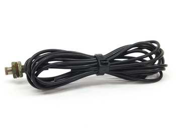 Omron E32-D11 fiber sensor cable coiled neatly with threaded barrel sensing tip visible at right