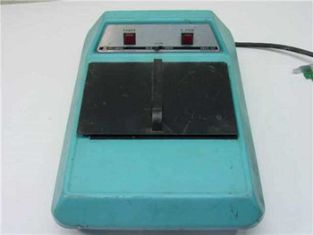X-Rite 303 Sensitometer front view showing teal housing, black film platen, Power and Expose buttons on brushed-metal panel
