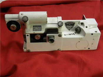 Photo-Sonics 16MM-1B high-speed 16mm motion picture camera body with 400ft take-up attachment, three-quarter view on red background showing overall condition