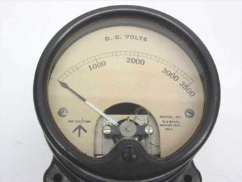 Close-up of voltmeter dial face showing D.C. VOLTS scale 0-3500, moving coil pointer, serial number, and 1945 date marking