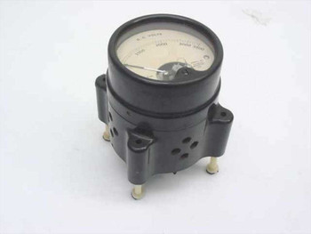 Vintage 0-3500V DC moving coil voltmeter in black housing mounted on base with rubber feet — three-quarter front view