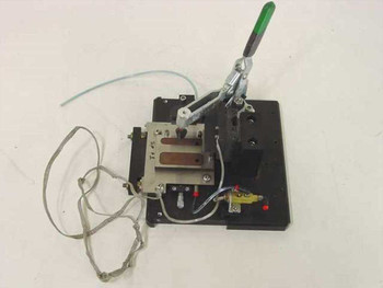 Custom PCB test jig fixture showing opposite angle — Carr Lane toggle clamp, brass pneumatic valve, red-capped fittings, and ribbon cables visible